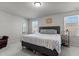 A well-lit bedroom featuring a comfortable bed, neutral walls, and ample natural light from the windows at 5432 Crescent Square St, Raleigh, NC 27616