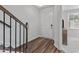 Inviting entryway featuring hardwood floors, stairs, and a view into a neutral living space at 5432 Crescent Square St, Raleigh, NC 27616