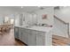 Open-concept kitchen island with stainless steel appliances and a sink at 5432 Crescent Square St, Raleigh, NC 27616