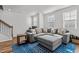 Well-lit living area with comfortable seating, modern decor, and wood floors at 5432 Crescent Square St, Raleigh, NC 27616