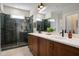 Modern bathroom featuring a dual sink vanity and a glass-enclosed shower with tiled walls at 548 Folk Song Way, Wendell, NC 27591