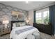 This bedroom boasts blue patterned walls, a soft bed, and natural light from a large window at 548 Folk Song Way, Wendell, NC 27591