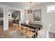 Stylish dining area with modern lighting fixture and an open flow to the kitchen for easy entertaining at 548 Folk Song Way, Wendell, NC 27591