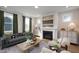 Inviting living room featuring a cozy fireplace, comfortable seating, and an abundance of natural light at 548 Folk Song Way, Wendell, NC 27591