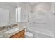 Bathroom features a granite countertop, sink, bathtub, shower, and a mirrored medicine cabinet, perfect for everyday routines at 563 Tomkins Loop, Cary, NC 27519