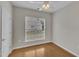 Bedroom with hardwood floors, natural light from a window, and a door providing privacy and easy access at 563 Tomkins Loop, Cary, NC 27519