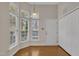 Bright breakfast nook with hardwood floors, multiple windows with blinds, and a closet for extra storage at 563 Tomkins Loop, Cary, NC 27519