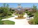 Beautiful clubhouse featuring a clock tower, water feature, landscaping and a walking path with bench seating at 563 Tomkins Loop, Cary, NC 27519