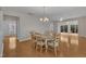 Elegant dining room with hardwood floors, chandelier, and lots of natural light, perfect for Gathering dinners at 563 Tomkins Loop, Cary, NC 27519