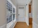 Inviting foyer with hardwood floors, white trim, and a front door with sidelights, creating a bright entryway at 563 Tomkins Loop, Cary, NC 27519