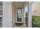 Inviting front entry featuring white columns and a glass storm door with a Ring doorbell for added security at 563 Tomkins Loop, Cary, NC 27519