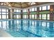 Indoor swimming pool featuring a large number of windows and a decorative ceiling at 563 Tomkins Loop, Cary, NC 27519