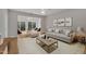 Bright living room with lots of natural light and access to a sunroom overlooking a private backyard at 563 Tomkins Loop, Cary, NC 27519