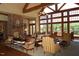 Comfortable lounge area featuring a fireplace, seating and lots of natural light from large windows at 563 Tomkins Loop, Cary, NC 27519