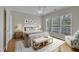 Bright primary bedroom features hardwood floors, lots of natural light and ensuite bath at 563 Tomkins Loop, Cary, NC 27519
