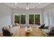 Cozy sun room featuring lots of light and sliders leading to patio and fenced yard at 563 Tomkins Loop, Cary, NC 27519