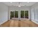 Bright sun room featuring hardwood floors and sliders that lead to a private patio at 563 Tomkins Loop, Cary, NC 27519