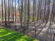 Beautiful backyard view featuring a black metal fence, grass, and trees at 5816 Sand Pebble Pl, Raleigh, NC 27613