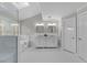 Elegant bathroom with double vanity, bathtub, separate glass shower and skylight at 5816 Sand Pebble Pl, Raleigh, NC 27613
