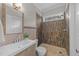 Modern bathroom features a tiled shower, stylish vanity, and natural light at 5816 Sand Pebble Pl, Raleigh, NC 27613