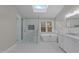 Bright bathroom with walk-in shower, soaking tub, and vanity with great natural light at 5816 Sand Pebble Pl, Raleigh, NC 27613