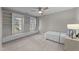 Cozy bedroom featuring built-in shelves, windows, and a comfortable sleeping space at 5816 Sand Pebble Pl, Raleigh, NC 27613