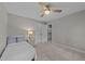Inviting bedroom with a ceiling fan, a nightstand, and a doorway leading to the hallway at 5816 Sand Pebble Pl, Raleigh, NC 27613