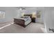 Bright bedroom featuring a large bed, bedside tables, and natural light from windows at 5816 Sand Pebble Pl, Raleigh, NC 27613