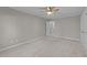 Bright and airy bedroom with plush carpeting, ceiling fan, and access to the hallway at 5816 Sand Pebble Pl, Raleigh, NC 27613