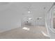 Large bonus room with neutral carpet, many windows, and ceiling fan at 5816 Sand Pebble Pl, Raleigh, NC 27613