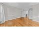 Bonus room with hardwood floors, white trim, and built-in bookcases, that could be used as an office at 5816 Sand Pebble Pl, Raleigh, NC 27613