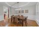 Dining room with a six person table, detailed trim, and decorative lighting at 5816 Sand Pebble Pl, Raleigh, NC 27613