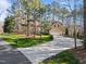 Long, curved driveway leading to a home surrounded by lush greenery and mature trees at 5816 Sand Pebble Pl, Raleigh, NC 27613