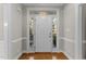 Bright foyer with classic trim details, hardwood floor, and sidelights framing the front door at 5816 Sand Pebble Pl, Raleigh, NC 27613
