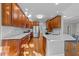 Bright kitchen featuring wood cabinets, stainless steel appliances, and white countertops at 5816 Sand Pebble Pl, Raleigh, NC 27613