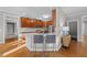 Open kitchen with wood cabinets, stainless appliances, white countertops, and a breakfast bar with seating at 5816 Sand Pebble Pl, Raleigh, NC 27613