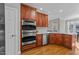 Kitchen details showing stainless steel oven, dishwasher and sink, along with wood cabinets at 5816 Sand Pebble Pl, Raleigh, NC 27613