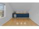 Bright kitchenette features blue cabinets, granite countertops, and a convenient beverage refrigerator at 5816 Sand Pebble Pl, Raleigh, NC 27613
