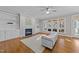 Bright living room with fireplace, built-in shelves, hardwood floors and a large window overlooking backyard at 5816 Sand Pebble Pl, Raleigh, NC 27613