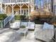 Back patio with comfortable seating, umbrella and view of the landscaped yard at 5816 Sand Pebble Pl, Raleigh, NC 27613