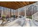 Covered patio with wicker furniture, concrete flooring, and wooded views at 5816 Sand Pebble Pl, Raleigh, NC 27613