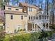 A two-story home featuring a porch and patio with a lush green lawn and landscape at 5816 Sand Pebble Pl, Raleigh, NC 27613