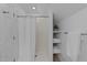 Clean shower featuring white tiles, with convenient built-in storage shelves and a shower curtain at 5816 Sand Pebble Pl, Raleigh, NC 27613