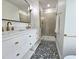 Beautiful bathroom featuring gold hardware, intricate floors, and walk-in shower at 5920 Holly Dr, Raleigh, NC 27616