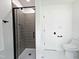 Bathroom with tiled shower, toilet, hand towel rack, and tiled floors at 5920 Holly Dr, Raleigh, NC 27616