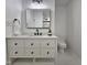 Modern bathroom features a sleek vanity, lighted mirror, and tiled floors at 5920 Holly Dr, Raleigh, NC 27616