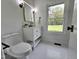 Bathroom features a white vanity, black fixtures and a window overlooking the front yard at 5920 Holly Dr, Raleigh, NC 27616