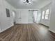 Large bedroom featuring dark wood floors, barn door and modern lighting at 5920 Holly Dr, Raleigh, NC 27616