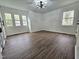 Bright bedroom with dark wood floors, lots of windows and modern lighting at 5920 Holly Dr, Raleigh, NC 27616