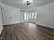 Bright bedroom featuring dark wood floors, barn door and modern lighting at 5920 Holly Dr, Raleigh, NC 27616